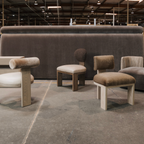 Modern furniture set including chairs and ottomans in a warehouse setting