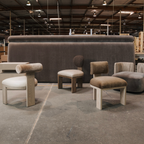 Modern furniture including chairs and ottomans in a warehouse setting