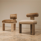 Two modern chairs with brown leather seats and wooden frames on a neutral background