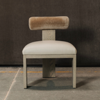 Chair with beige Cylindrical bolster backrest and seat on a dark floor and wall background