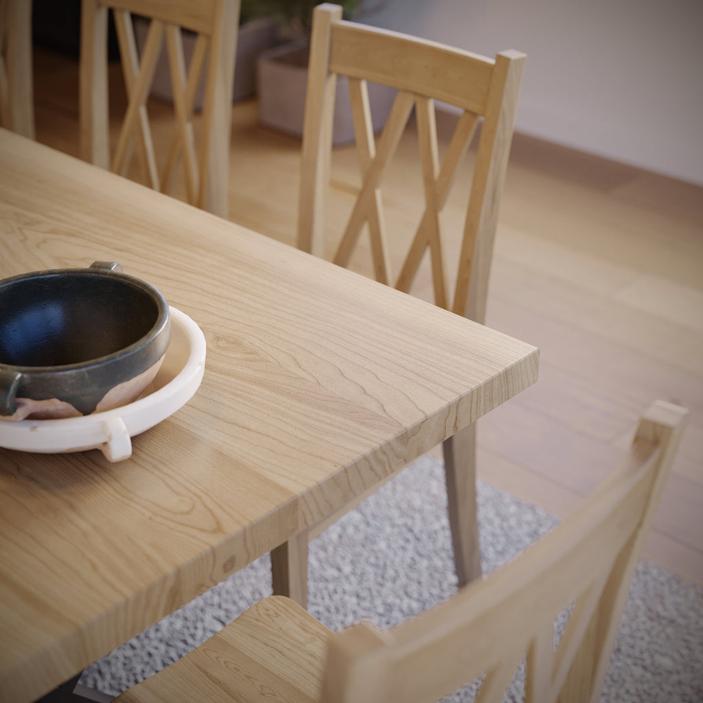 close up image of a maple dining table with black metal legs