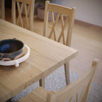 close up image of a maple dining table with black metal legs