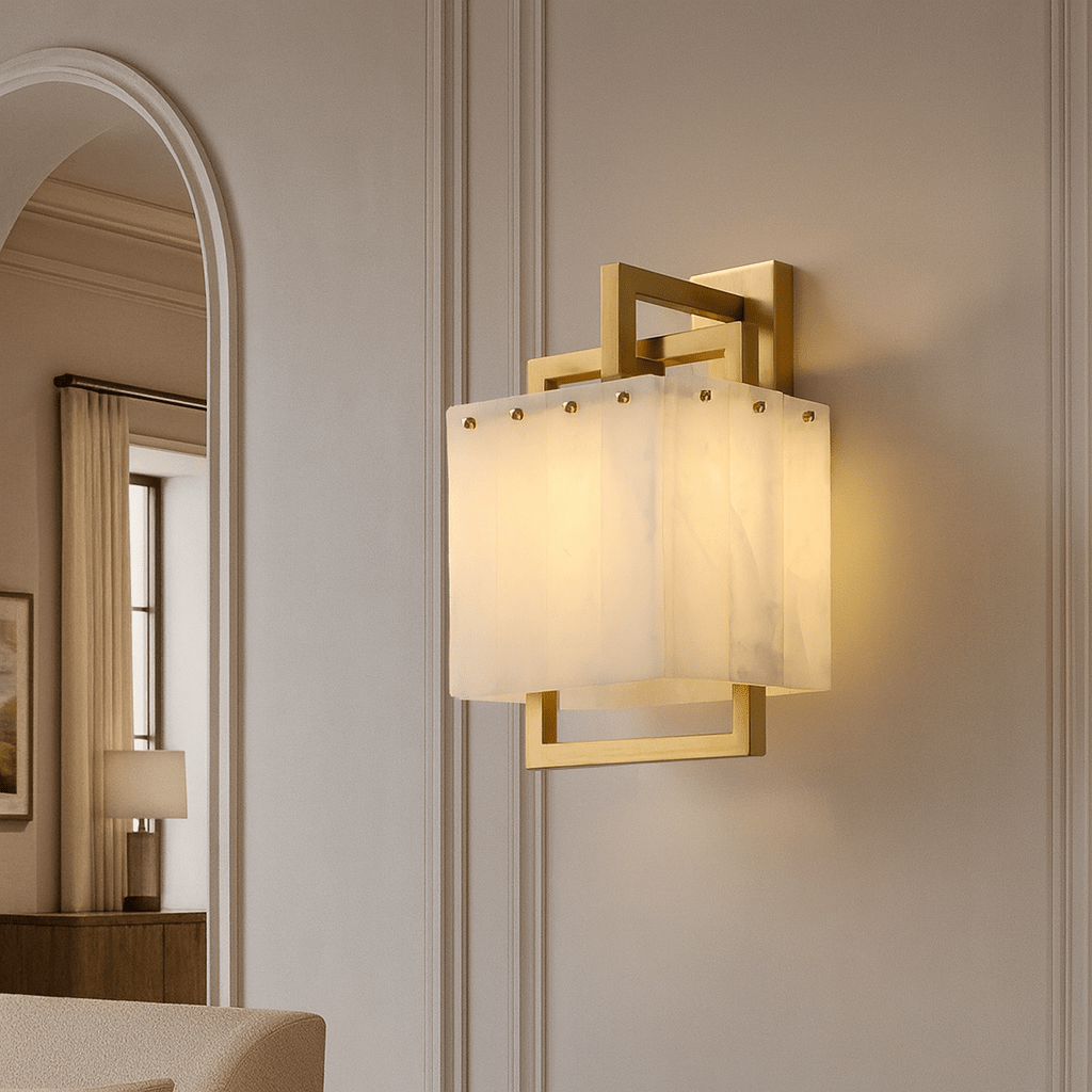 Stuart sconce with glowing marble shade on a brass frame