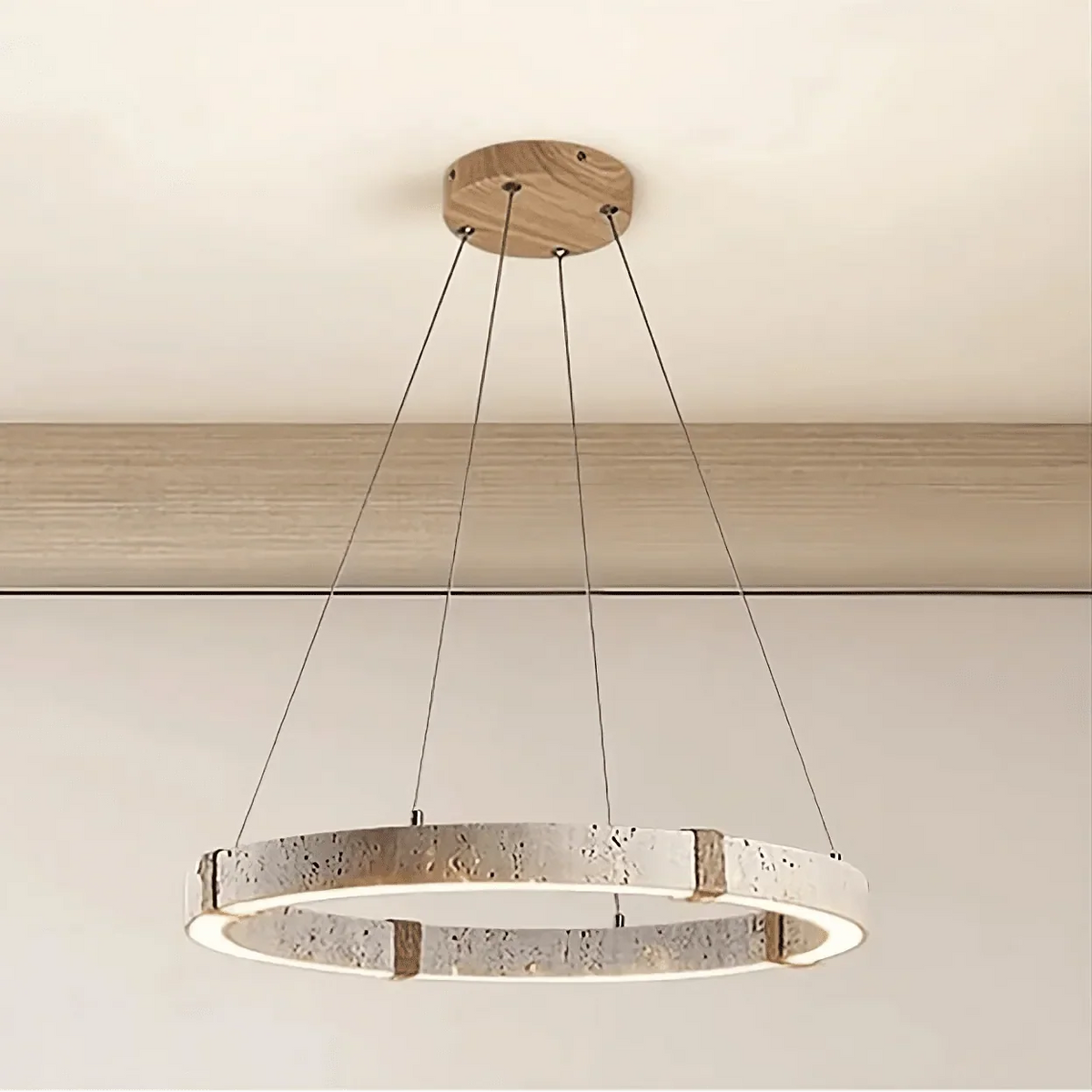 Danford travertine chandelier illuminated over a dining table