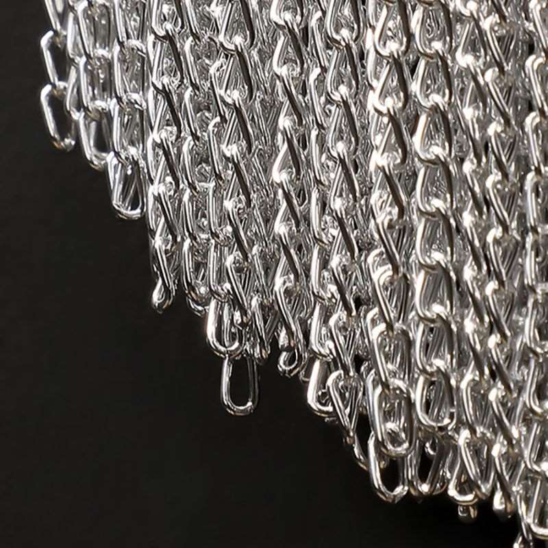 Cadena tassel wall sconce illuminated beside a bed