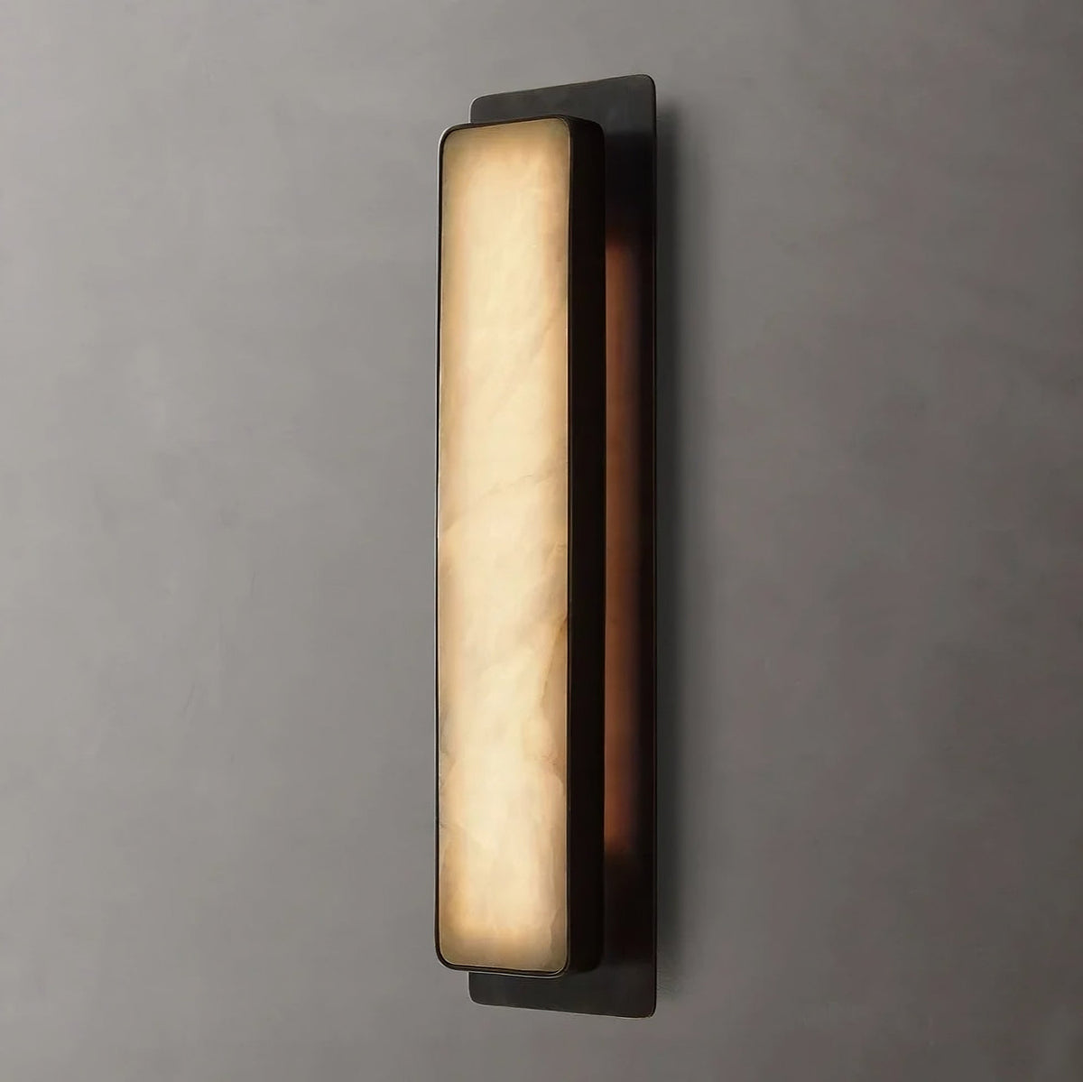 Capri sconce with glowing marble shade on a steel frame