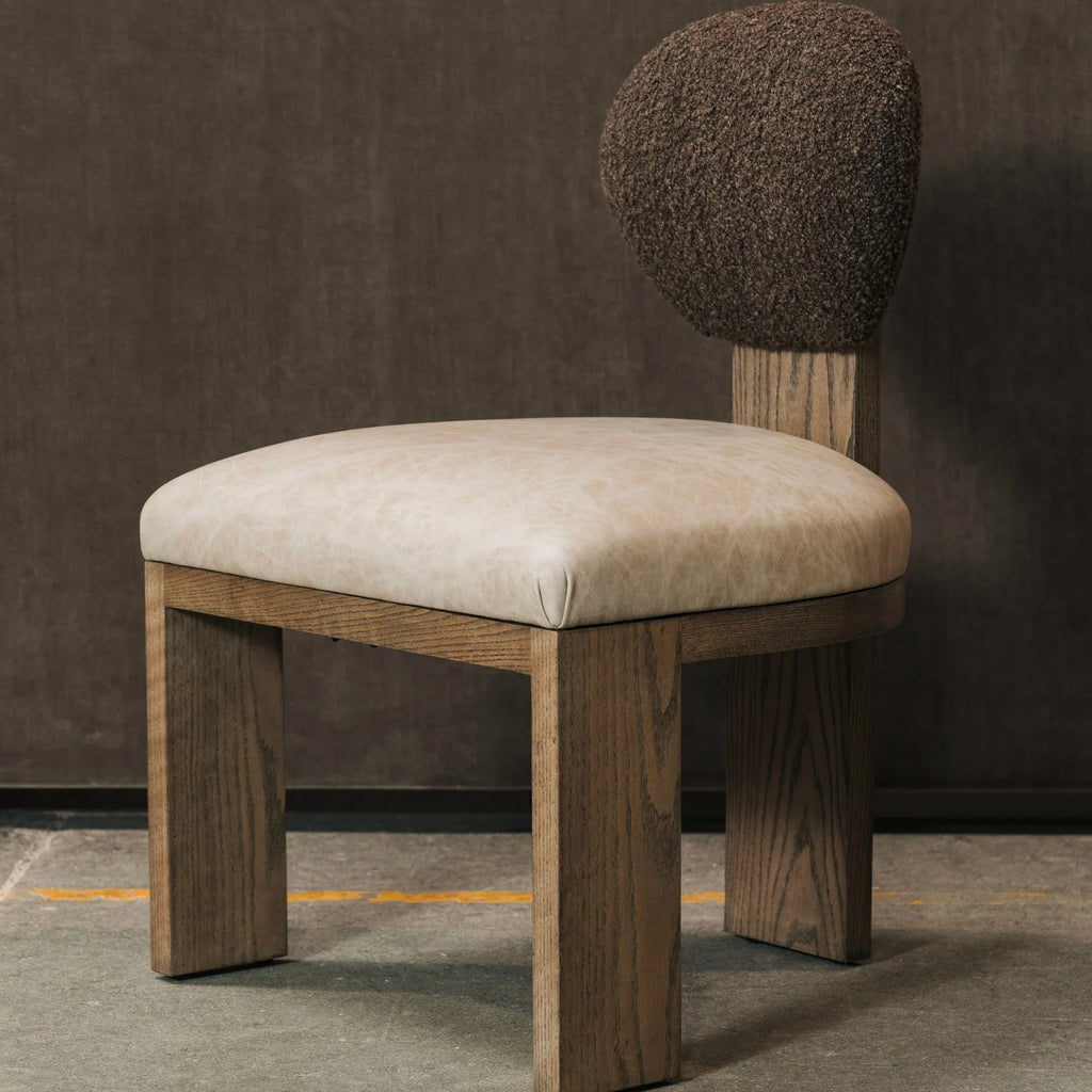 Chair with a boucle backrest and beige leather on a dark background